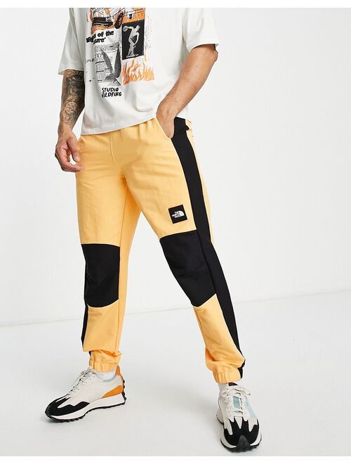 The North Face Phlego track sweatpants in orange
