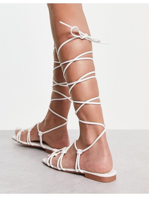 Raid Wide Fit Exclusive strappy ghillie tie sandals in off white