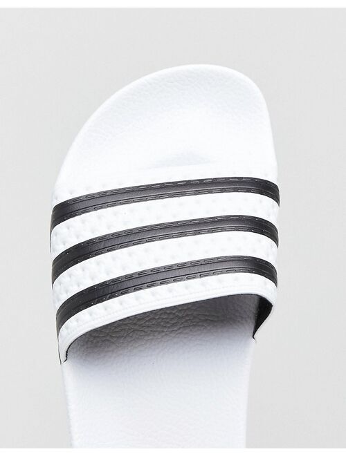 adidas Originals adilette sliders in white and black