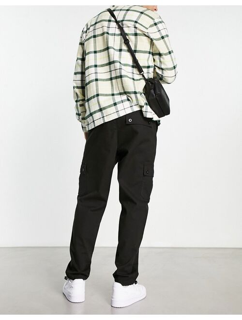 ASOS DESIGN cargo tapered pants in black with toggles
