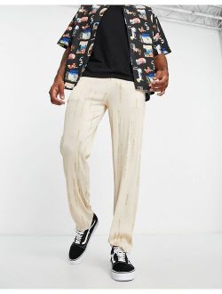 Liquor N Poker straight leg plisse pants in beige with all over japanese text print
