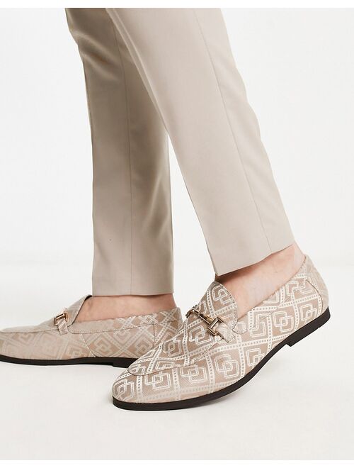 ASOS DESIGN loafers in brown monogram design with gold snaffle