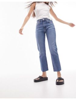 mid rise straight jeans with raw hem in mid blue