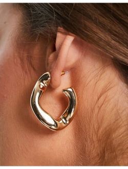 hoop earring with twist link design in gold tone