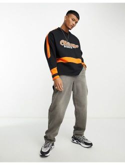 oversized hockey jersey with city print in black and orange