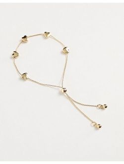 friendship bracelet with heart detail in gold tone