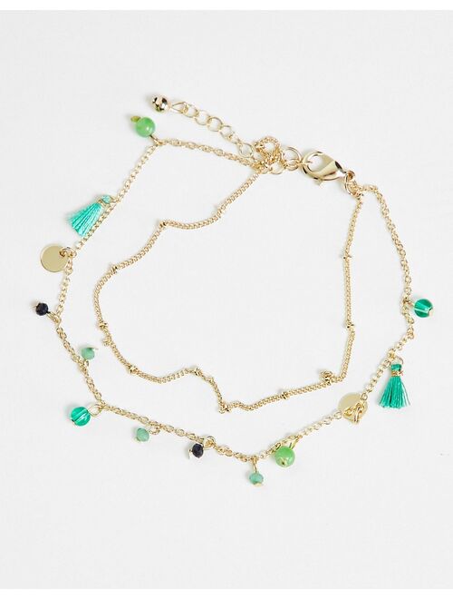 ASOS DESIGN multirow anklet with green bead and tassel design in gold tone