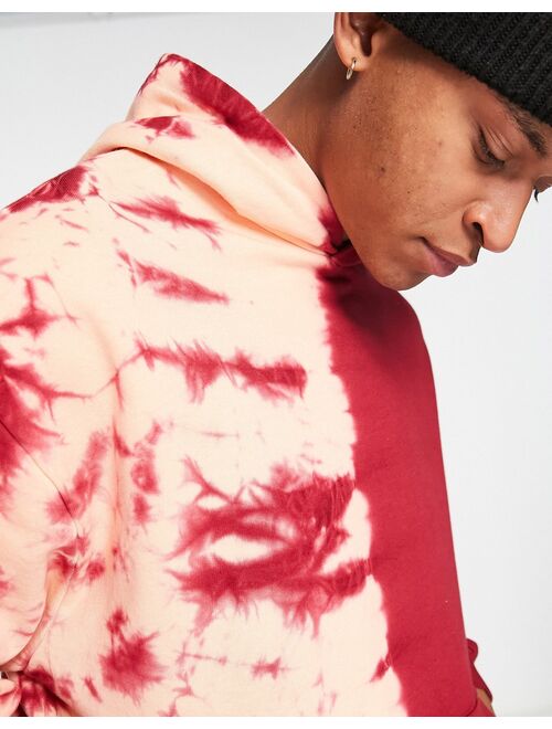 ASOS DESIGN oversized hoodie in red with placement tie dye