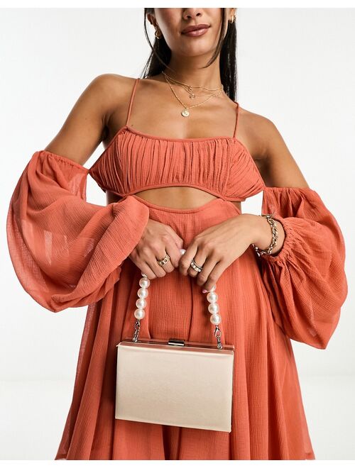 True Decadence clutch bag with pearl embellished strap in champagne satin