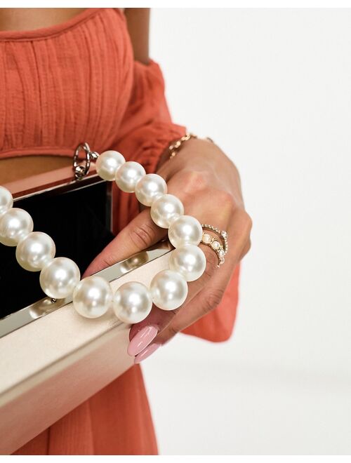 True Decadence clutch bag with pearl embellished strap in champagne satin