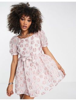 mini babydoll dress in pink floral jacquard with bow