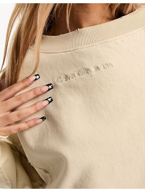 Calvin Klein Jeans cropped crew neck seaming sweatshirt in beige - exclusive to ASOS