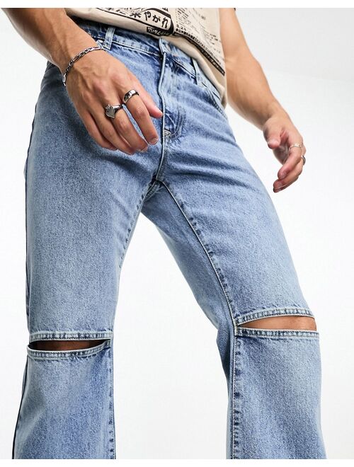 ASOS DESIGN flare jeans with open knees in mid wash blue
