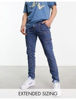 skinny jeans with carpenter detail in mid wash blue