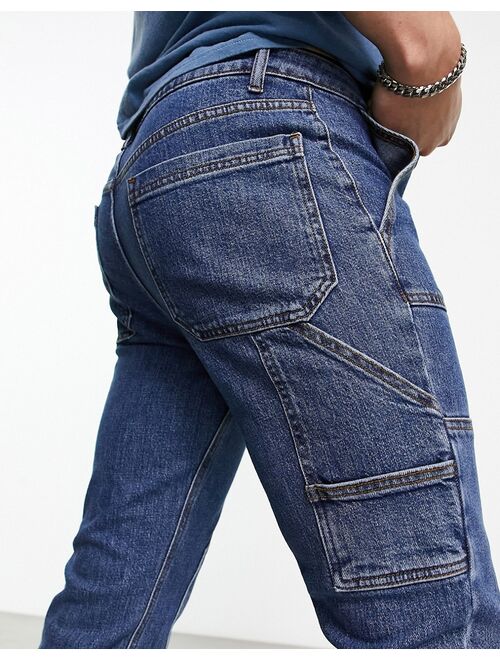 ASOS DESIGN skinny jeans with carpenter detail in mid wash blue