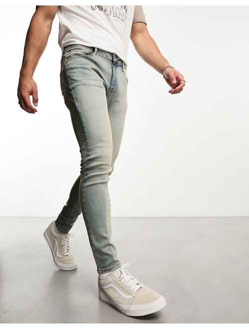 ASOS DESIGN spray on jeans with power stretch in mid wash tint