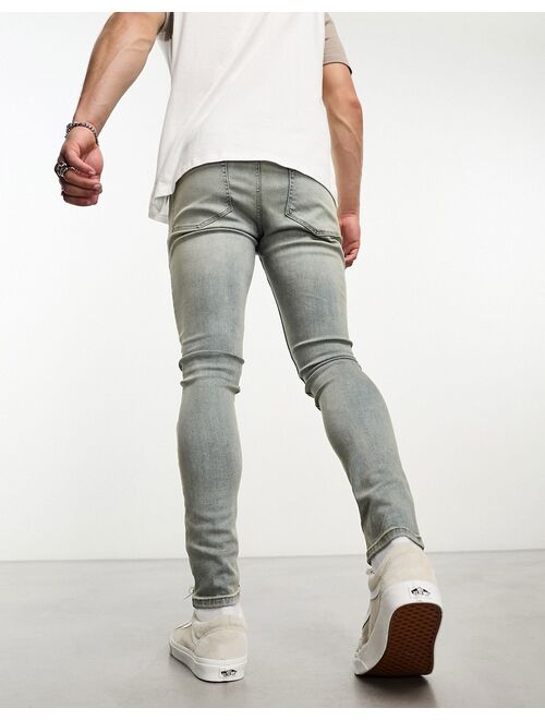 ASOS DESIGN spray on jeans with power stretch in mid wash tint