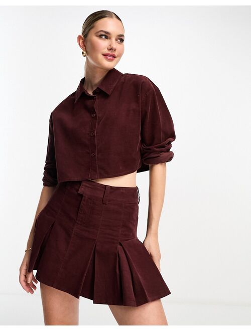 ASOS DESIGN cord pleated mini skirt in burgundy