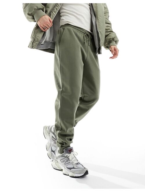 ASOS DESIGN tapered heavyweight sweatpants in washed khaki