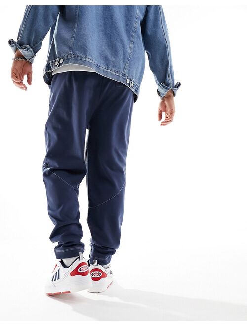ASOS DESIGN oversized sweatpants with contrast stitching in navy