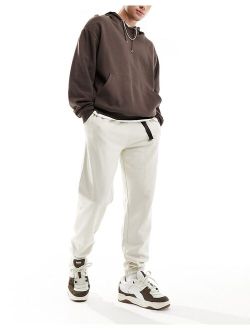 oversized sweatpants with cargo pocket and woven belt detail in beige