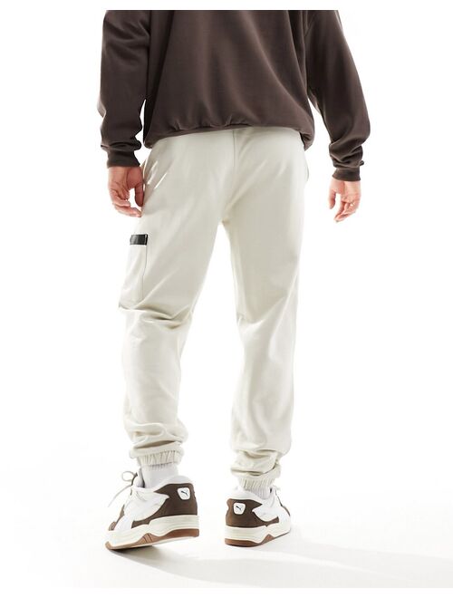 ASOS DESIGN oversized sweatpants with cargo pocket and woven belt detail in beige