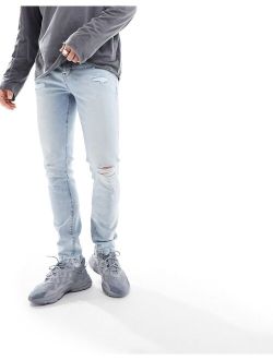 skinny jeans with rips in light blue tinted wash