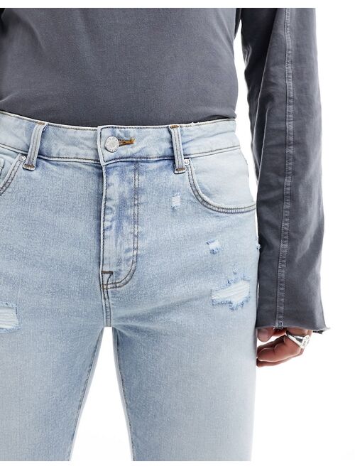 ASOS DESIGN skinny jeans with rips in light blue tinted wash