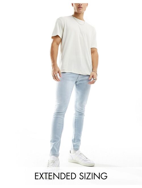 ASOS DESIGN spray on jeans with power stretch in light wash blue