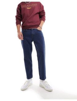 avi rigid tapered fit cropped jeans in mid wash